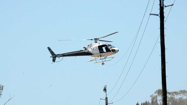 helicopter stringing new power lines along Tin Can Bay Rd Photo Craig Warhurst / The Gympie Times. Picture: Craig Warhurst