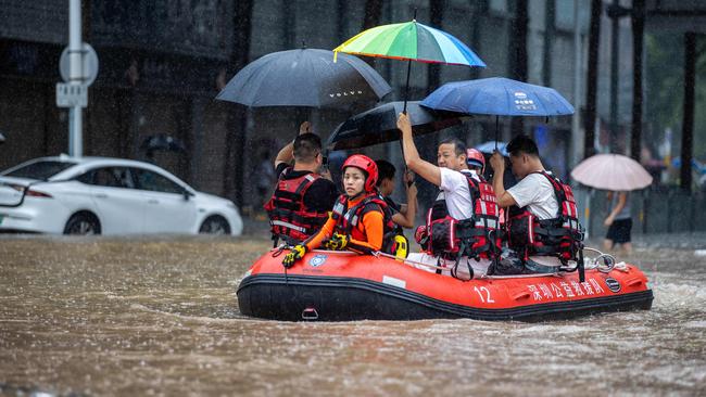 Rescue workers ride a boat along a flooded street in Shenzhen, in China's Guangdong province on September 8, 2023. Picture: AFP.