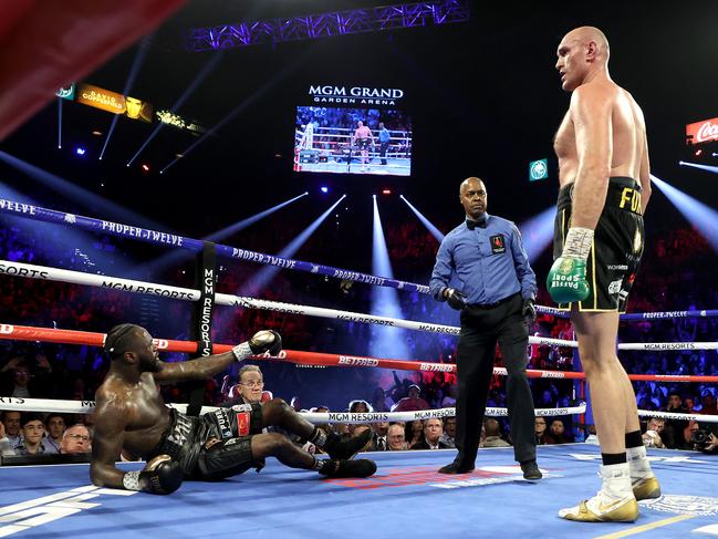 Tyson Fury stands over Deontay Wilder after knocking him down. Picture: Al Bello/Getty