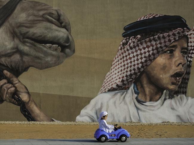 Transportation ... I took this photo in Abu Dhabi, at one of past September morning days, a painting on the wall grabbed my attention, due to it represents UAE past culture. It made me bring my son, dress him with the Local traditional outfit that he loves the most, and made him play around with his tiny car under the paint, which reflects the great progress and innovation, that UAE witnessed in saving its own precious culture background. Mustafa Jind is a recident of United Arab Emirates with Syrian nationality. Picture: Mustafa Jindi, Emirati, 1st Place, National Awards, 2017 Sony World Photography Awards;