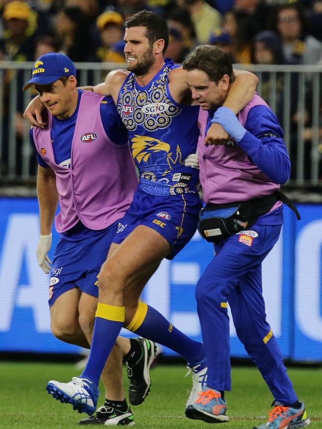 Jack Darling of the Eagles is assisted off the field with a right ankle injury against St Kilda. Picture: Will Russell/AFL Media/Getty Images