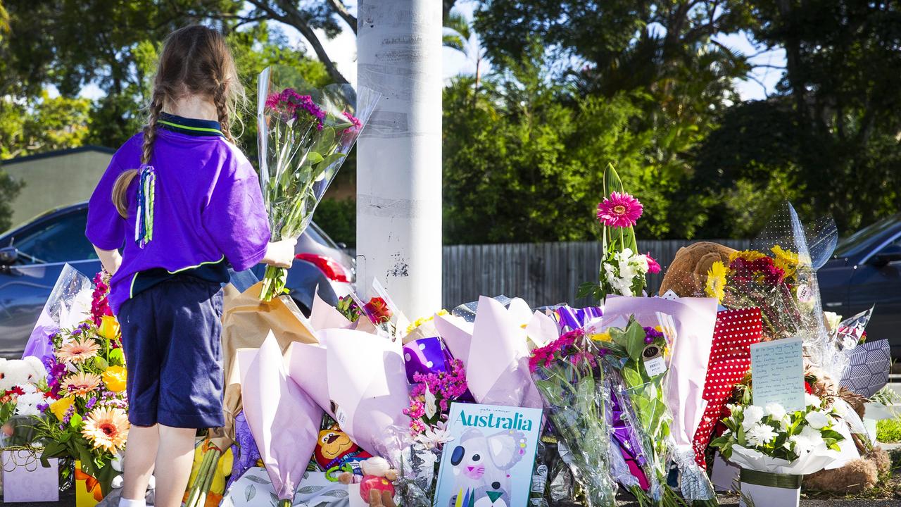 People pay tribute at the scene in Alexandra Hills where Matty Field and Kate Leadbetter were killed while walking their dog. Picture: NIGEL HALLETT