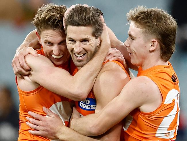 MELBOURNE, AUSTRALIA - JULY 14: (L-R) Lachie Whitfield, Callan Ward and Harvey Thomas of the Giants celebrate during the 2024 AFL Round 18 match between the Richmond Tigers and the GWS GIANTS at Melbourne Cricket Ground on July 14, 2024 in Melbourne, Australia. (Photo by Michael Willson/AFL Photos via Getty Images)