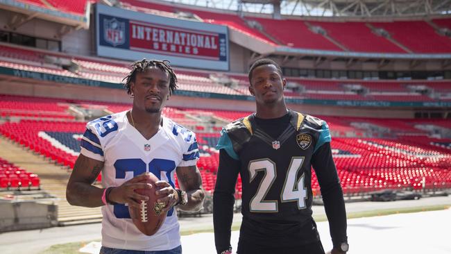Dallas Cowboys cornerback Brandon Carr, and Jacksonville Jaguars cornerback Will Blackmon pose for photographers at Wembley Stadium in London.
