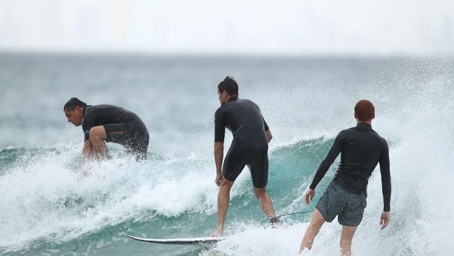 Surfers fill the stretch from Snapper Rocks down to Greenmount.