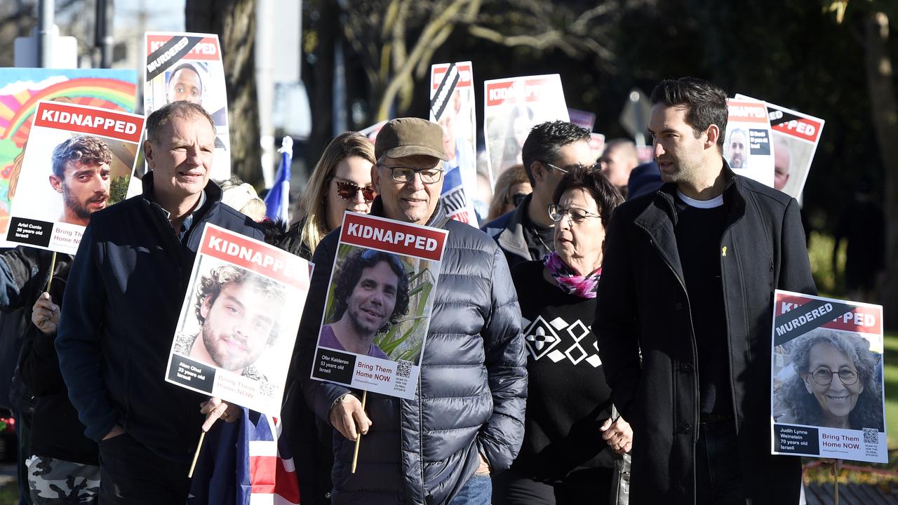 Many held signs with the portraits of people either killed or kidnapped on October 7. Picture: NewsWire / Andrew Henshaw