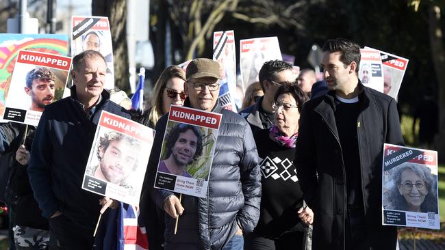 Many held signs with the portraits of people either killed or kidnapped on October 7. Picture: NewsWire / Andrew Henshaw