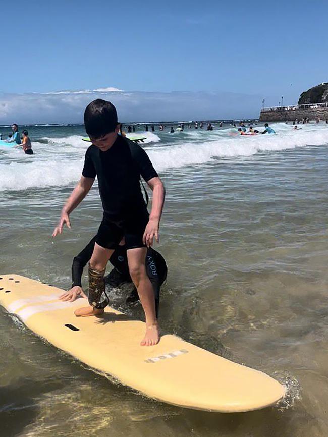 Eli Healy isn't just a force to be reckoned with on the footy field. Here he is giving surfing a crack. Picture: Bec Healy