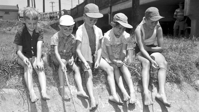 Children fish at Stones Corner in 1956, picture supplied. Picture: Ray/Saunders