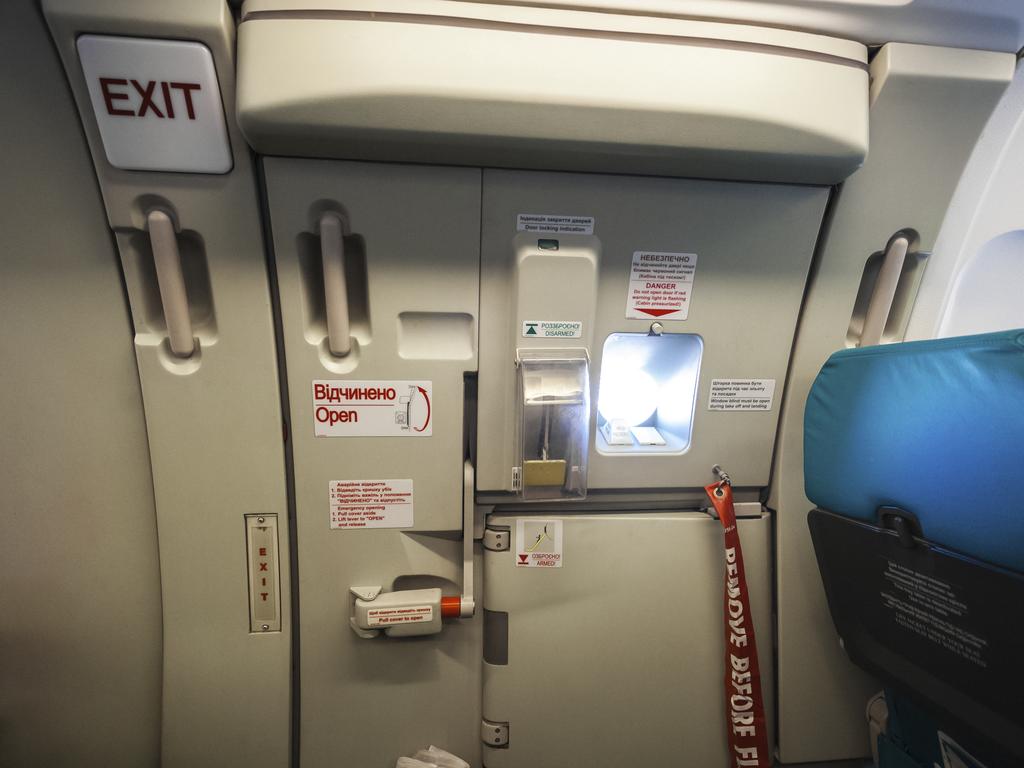 A woman mistook an emergency exit door for a toilet on a plane. Picture: Supplied