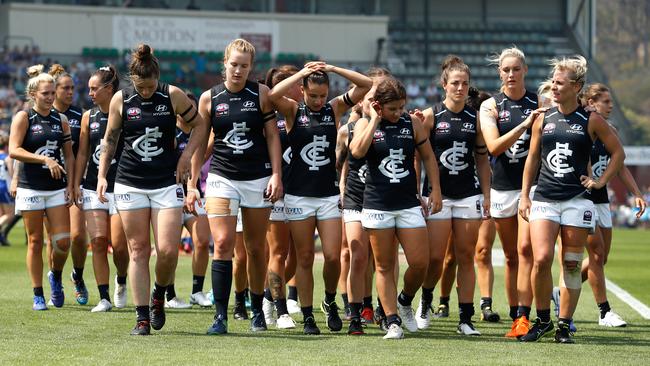 Carlton players leave the field after losing to North Melbourne.