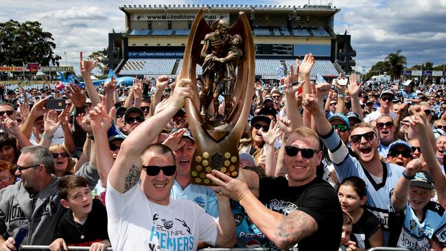 Paul Gallen and Clive Churchill Award winner Luke Lewis hold up the trophy. Picture : Gregg Porteous