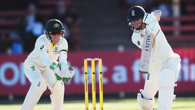 England's Tammy Beaumont drives as keeper Alyssa Healy looks on during Day 1 of Women's Ashes Test match between Australia and England at North Sydney Oval. Picture. Phil Hillyard