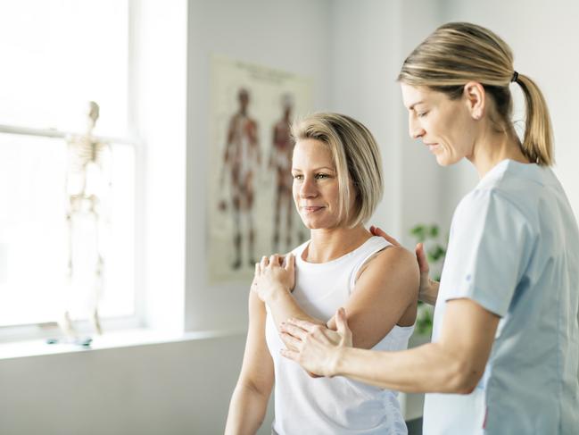 Modern rehabilitation physiotherapy worker with woman client