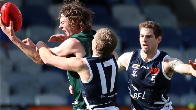 Hampden’s Rhys Buck deals with Ballarat Liam Canny (17) and Riley O'Keefe. Picture Yuri Kouzmin
