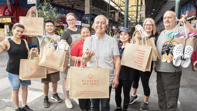 Preston Market centre manager Gary Zoubi and traders show off the centre’s eco bags. Pictur: Ellen Smith