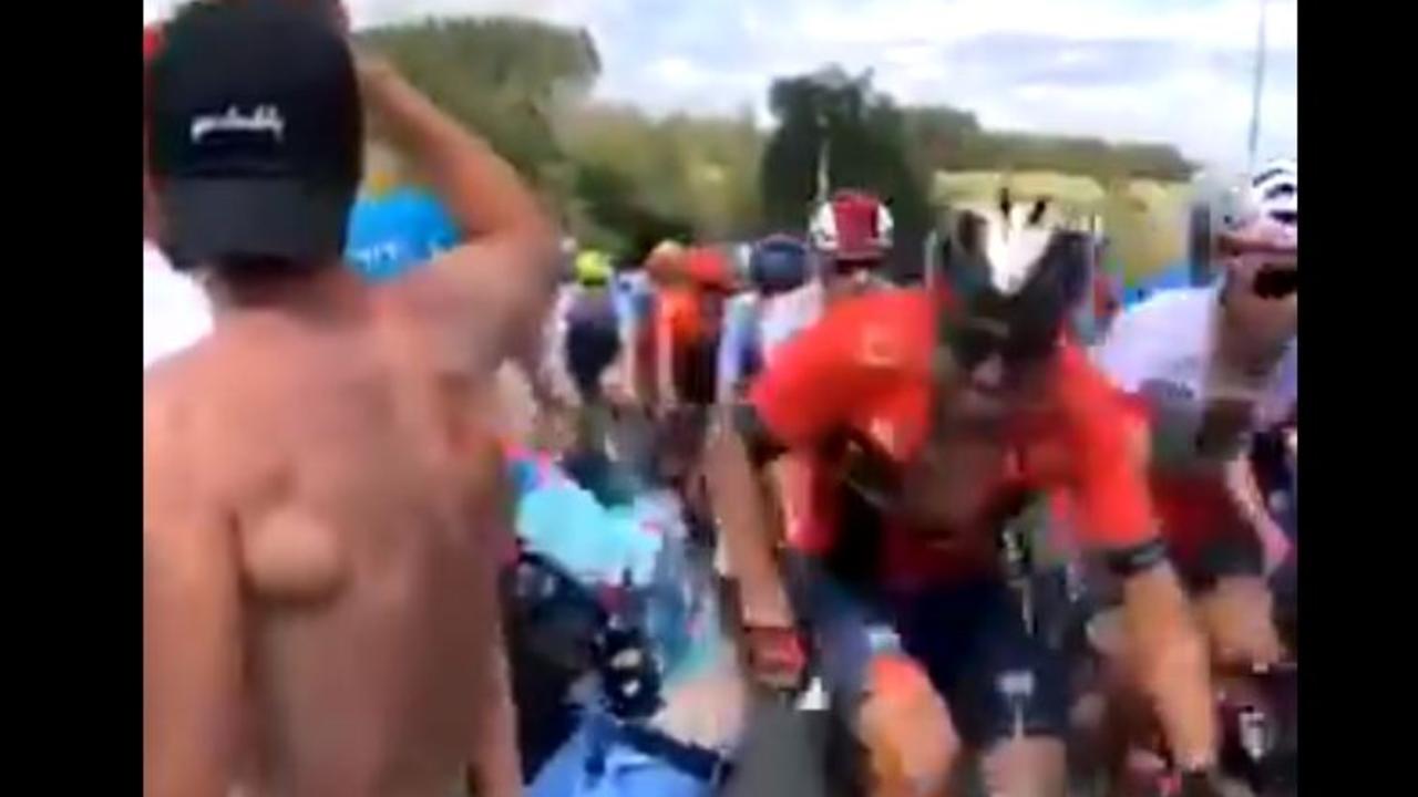A Tour de France cyclist spanks a cheeky fan.