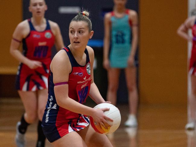 HOBART Sunday 16th June 2024. Tasmanian Netball League. Karana vs Devon at Hobart Netball Centre. Holly McConnon looks to pass for Karana Flames.Picture: Linda Higginson