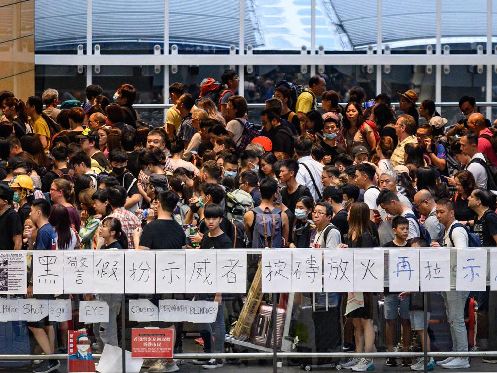 Protesters line up for a train at the airport station after a protest against police brutality and the controversial extradition bill on August 12, 2019. Picture: AFP