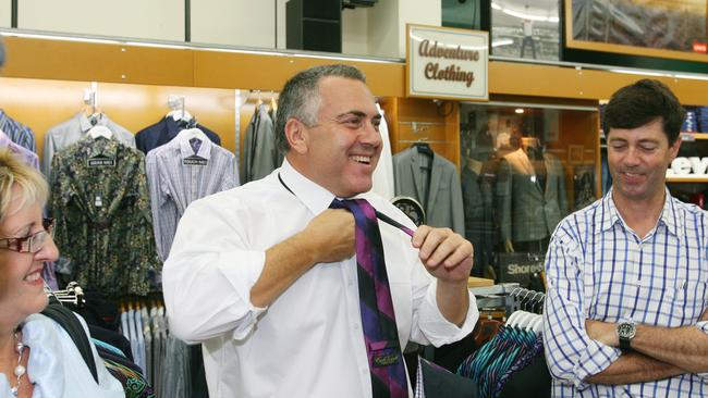 Joe Hockey made a quick visit to Stewarts in Rockhampton to buy a new tie after his luggage went missing on his flight in 2013. Pictured here with Michelle Landry (left) and Stewarts co-owner Mark Woods (right). Photo: Chris Ison / The Morning Bulletin
