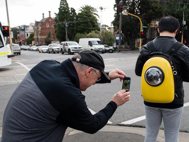 Owner Qi Zhang says he is often stopped by people once they notice his pet peeping out from the plastic pod. Picture: Craig Borrow