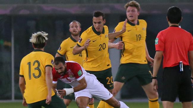 Australia's Harry Souttar (C Top) and Trent Sainsbury (R) view for the ball against Jordan's Baha Faisal (C) during the 2022 FIFA World Cup qualification group B football match between Australia and Jordan at the Kuwait Sports Club in Kuwait City on June 15, 2021. (Photo by Yasser Al-Zayyat / AFP)