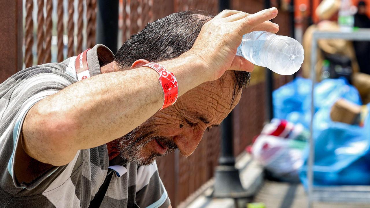 A Turkish pilgrim pours cold water from a bottle on his head to cool off as he waits in Saudi Arabia's holy city of Mecca on June 20. Picture: Abdel Ghani Bashir / AFP