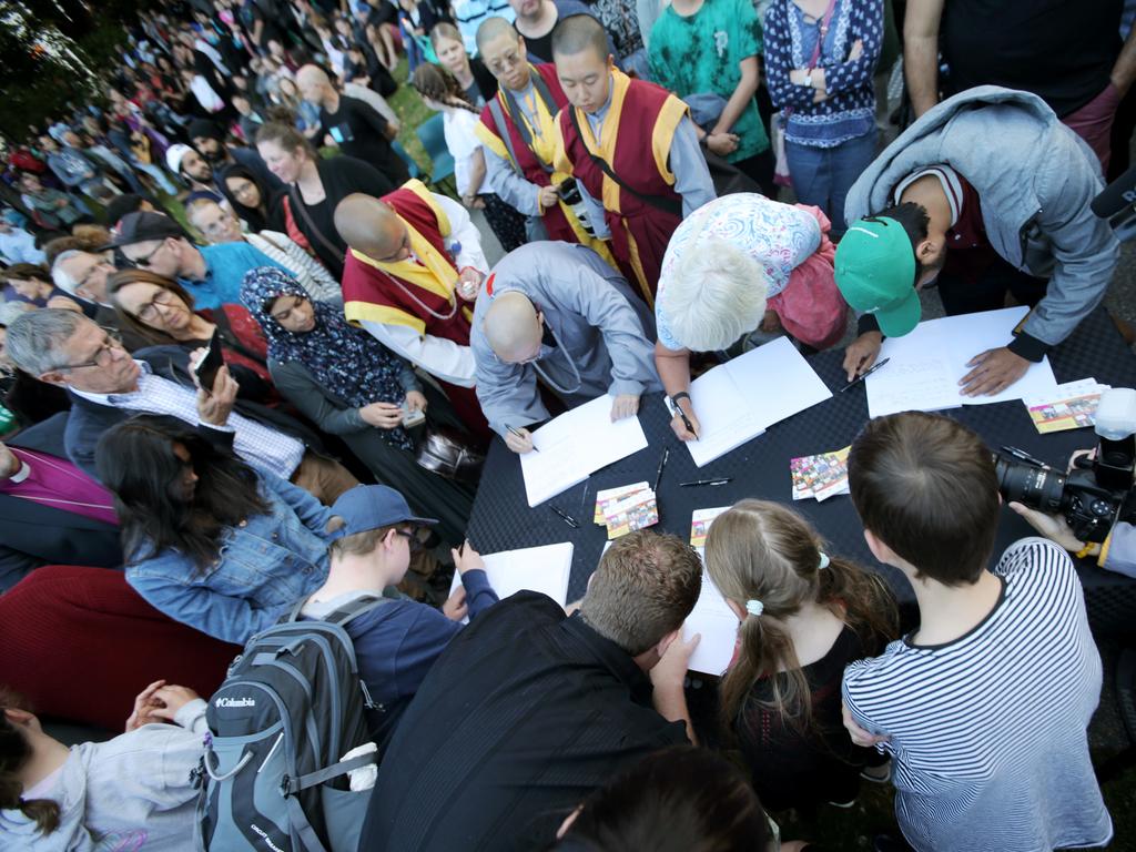 Members of the public line up to write messages of support at Hobart's vigil for Christchurch at Franklin Square. Picture: PATRICK GEE