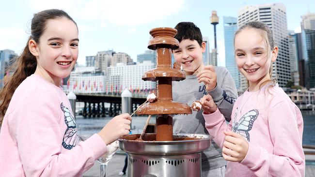 10 year old triplets Adelisse, Preston and Marielle Pecoraro eating chocolate in Darling Harbour for World Chocolate Day. Picture: Tim Hunter.