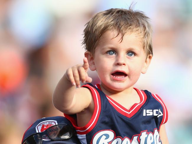 A young Roosters supporter watches them in action against Cronulla Sharks. Picture: Getty Images.