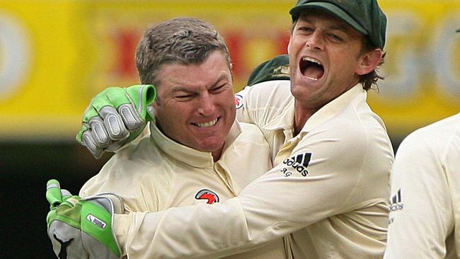 Adam Gilchrist (R) hugs Stuart MacGill after claiming his 200th Test wicket.