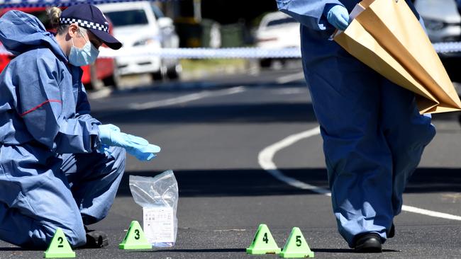 Forensic pick up spent shells from the road. Police investigate after a man and a child are in hospital after a shooting at a Thomastown home in Darebin drive. Picture: Nicole Garmston