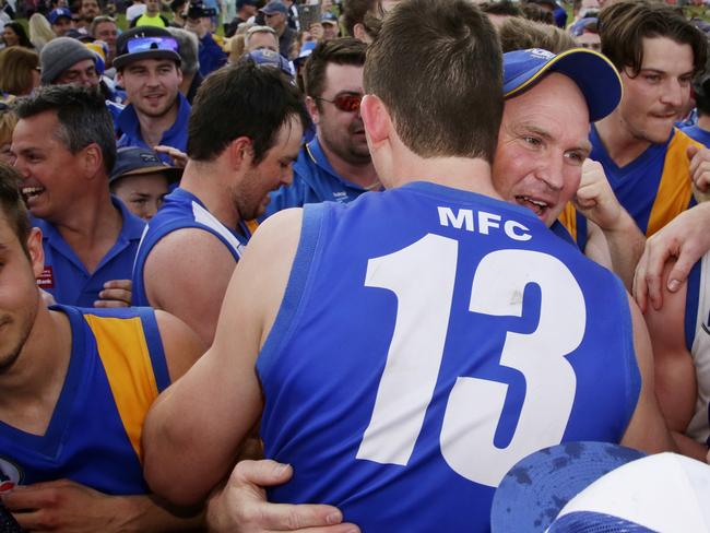 Coach Garry Ramsay (in cap) and Jack Langford of Macleod celebrate their victory after the NFL grand final between Greensborough and Macleod played Preston City Oval on Saturday, September 19, 2015, in Preston, Victoria, Australia. Picture: Hamish Blair