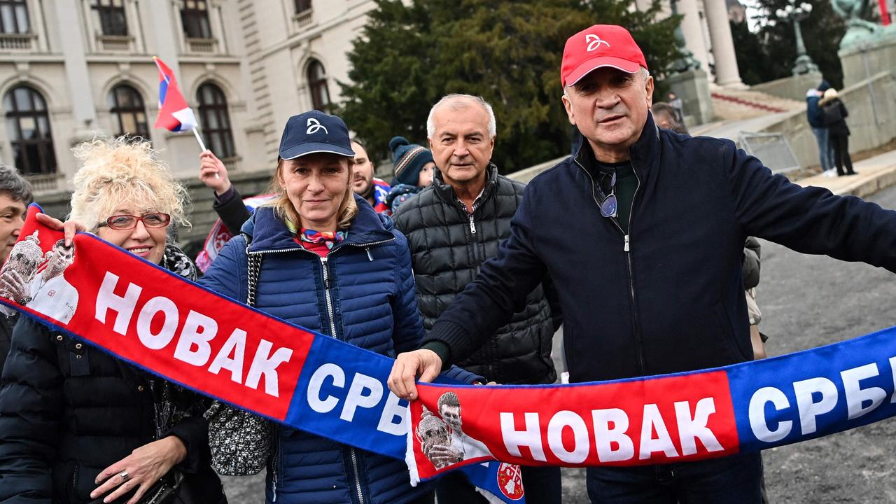 Srdjan Djokovic (R) and Dijana Djokovic (second from left) hit out in defence of their son. (Photo by Andrej Isakovic / AFP)