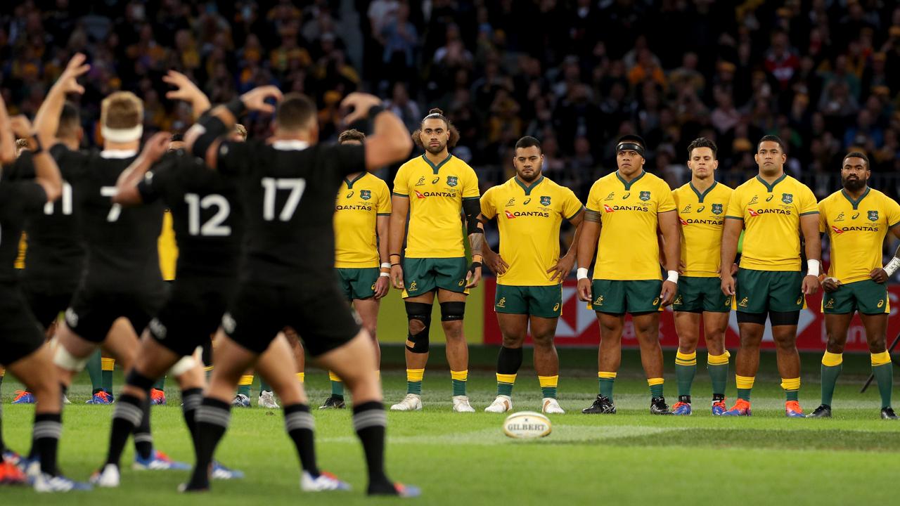 The Wallabies look on as the All Blacks perform the Haka.