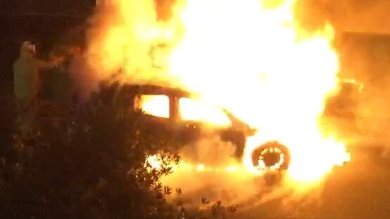 Emergency services worked to put out the torched car at Biggera Waters. 