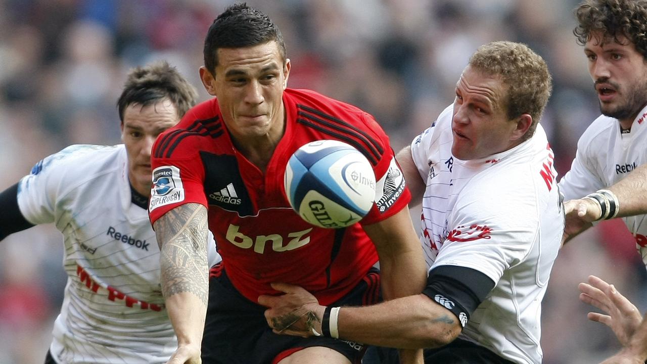 Crusaders star Sonny Bill Williams is tackled by Sharks players at Twickenham.