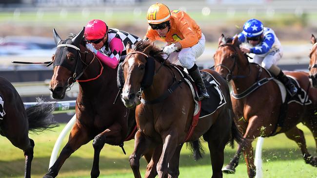 Jockey Jeff Lloyd (center) rides Tyzone to victory in race 1, the BenchMark 95 Handicap, during the Treasury Brisbane Ladies Oaks Day at Doomben Racecourse in Brisbane, Saturday, May 26, 2018. (AAP Image/Albert Perez) NO ARCHIVING, EDITORIAL USE ONLY