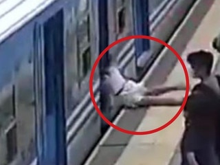 Woman faints and falls under moving train