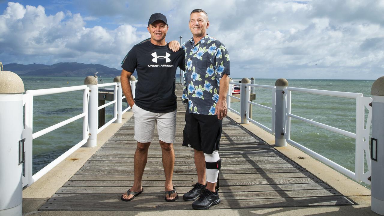 Diving mates Peter Kocica with shark attack survivor Rick Bettua, who was savagely attacked by a bull shark off Hinchinbrook Island. Picture: Lachie Millard