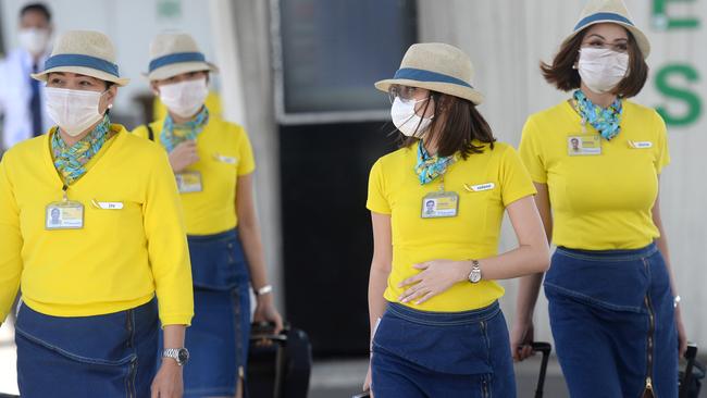 Empty scenes at the international terminal as travellers in Sydney wear cautionary face masks as the coronavirus to is raised to pandemic status. Picture: Jeremy Piper