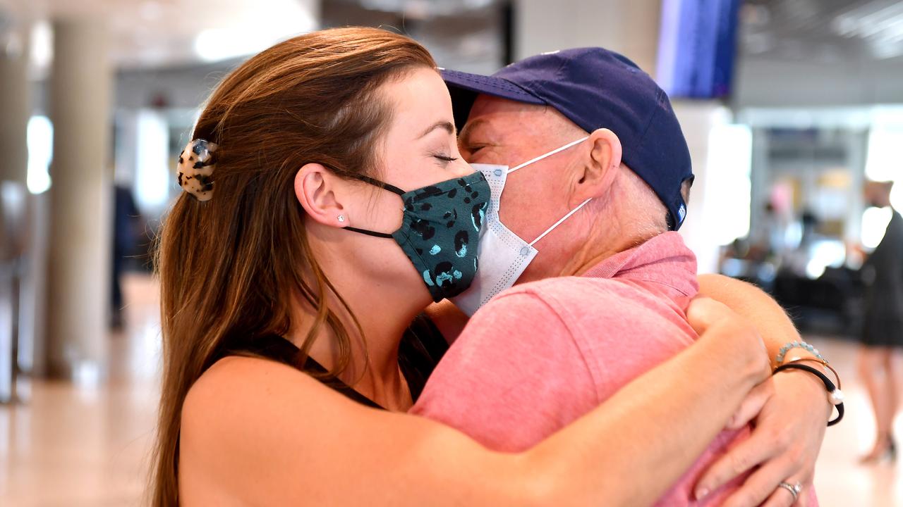 Rebecca Underhill hugs her dad Paul Gimpel after arriving on Qantas flight GF504 from Sydney to Brisbane. Picture: John Gass