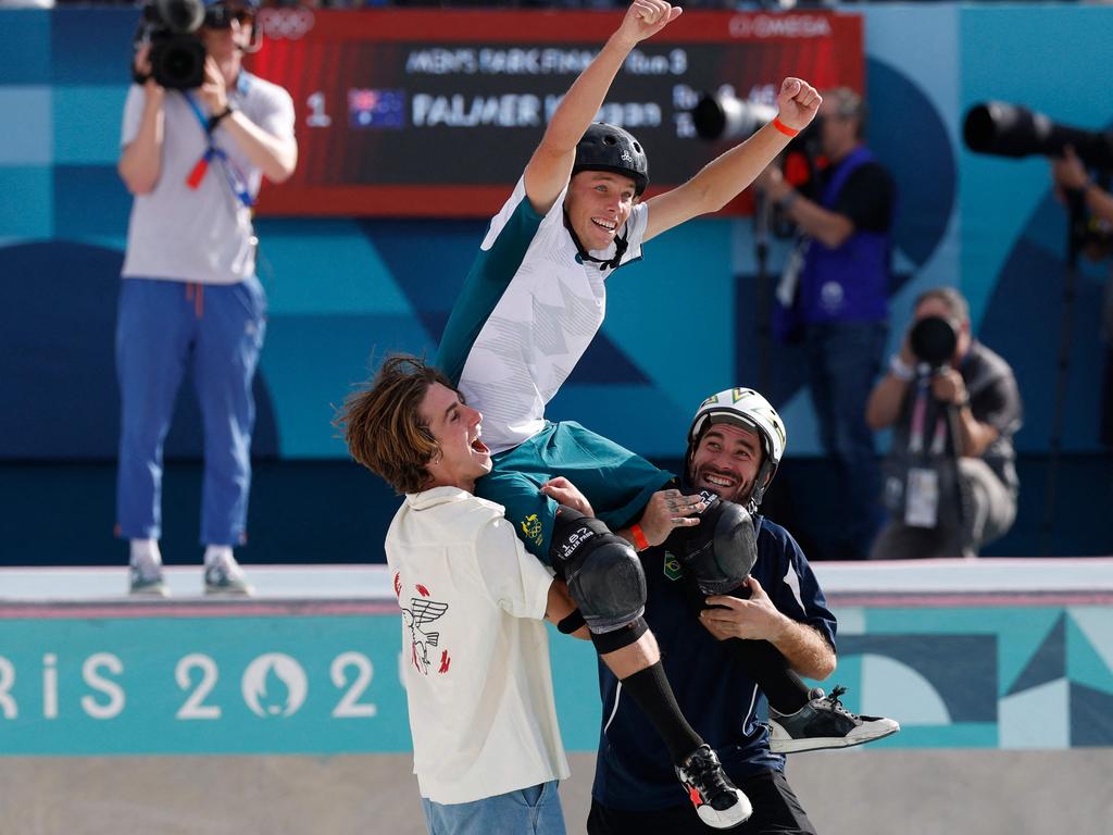 The obvious camaraderie among competing skateboarders was touching, with a triumphant Keegan Palmer held aloft by the USA’s Tate Carew, left, and Brazil's Pedro Barros. Picture: Odd Andersen/AFP