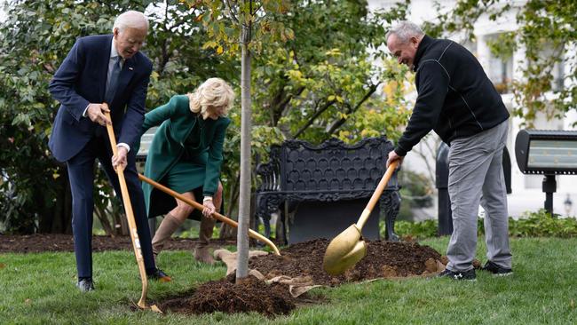 Joe and Jill Biden plant a tree with grounds superintendent Dale Haney to celebrate his 50 years working at the White House. Picture: AFP