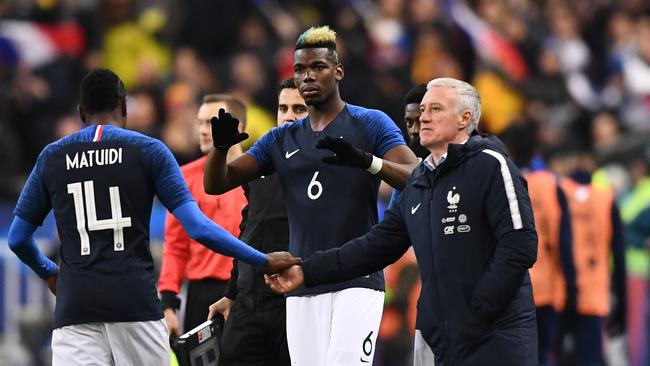 France's midfielder Paul Pogba (C) prepares to enter the football pitch to play and replace France's midfielder Blaise Matuidi (L)