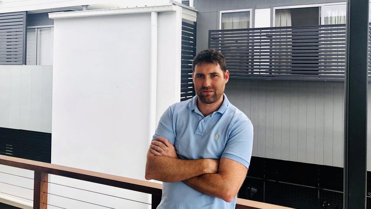 Fire nightmare: Surgeon Shaun McCrystal near the neighbouring apartment block that experts said was built too close, and without all the fire resistant materials.