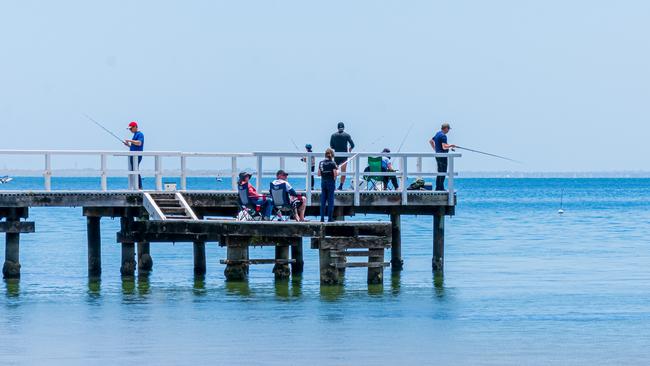 People fishing on Daveys Bay jetty, Mount Eliza about 12.20pm on New Year’s Day. Picture: Geoff Chatfield, Frankston South.