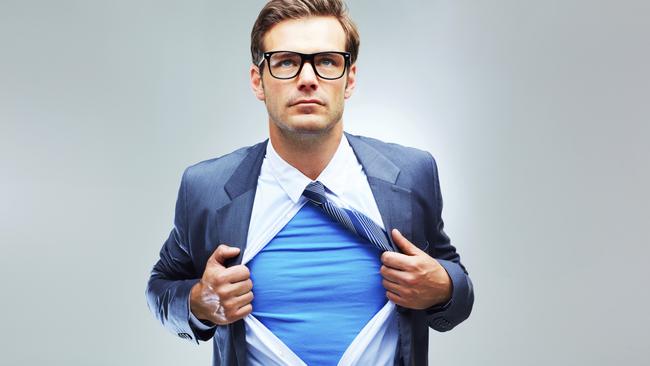 A studio shot of a businessman ripping open his shirt and exposing a costume underneath. Picture: iStock