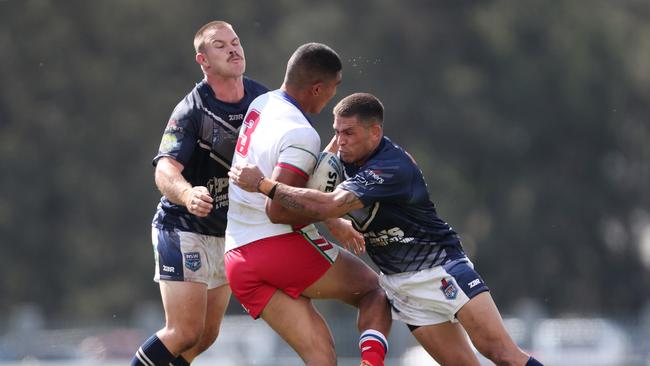 Will Smith (right) making a tackle for Newcastle. Picture: Sue Graham