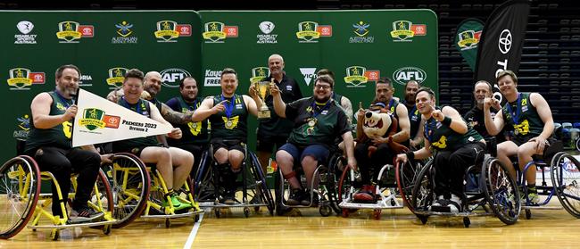 MELBOURNE, AUSTRALIA - NOVEMBER 05: Tasmania pose with the premiership cup after winning the Division 2 Grand Final match between Tasmania and NSW/ACT during the 2023 Toyota AFL Wheelchair National Championships Grand Final Day at State Netball Hockey Centre on November 05, 2023 in Melbourne, Australia. (Photo by Josh Chadwick/AFL Photos/via Getty Images)